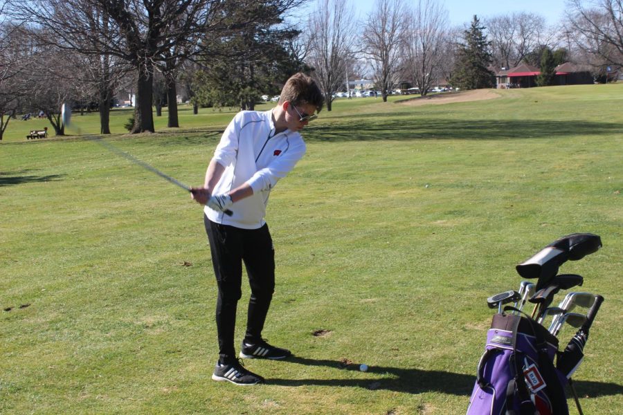  Junior Bryn Ostby practices his swing at the Monona Golf Course, where the team practices. 
The biggest challenges, coach Tina Lindsey said, is the size of the team, as it is made up of only three golfers, and who also compete as individuals.
