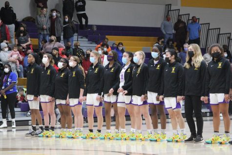 Girls Varsity Basketball team lines up for the national anthem during the East vs. La Follette game.