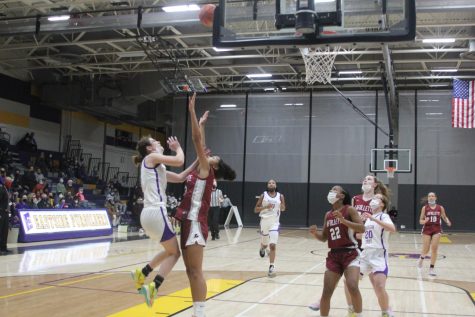 Senior, co-captain Ava Erhlinger shots on La Follette, taking some air as her teammates run in for an assist. Erhlinger is one of only two seniors on the team this year.