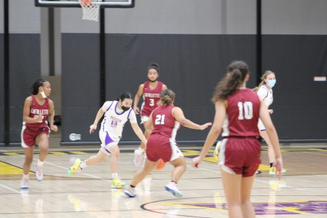 Junior Nadia Keokanya races to keep control of the ball, against four opposing players at once. The night ended with a final score of 84-48 in favor of La Follette.